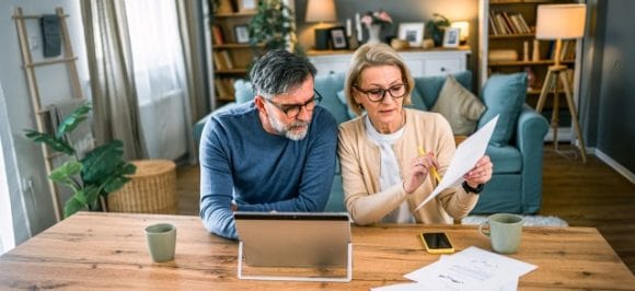 In the picture, you can see an elderly couple watching a documentary.