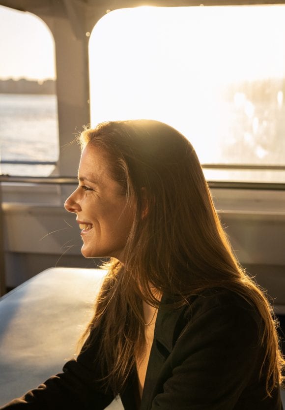 Woman on ferry in New York looking for banking jobs
