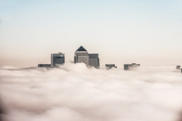 skyscrapers of the modern city skyline through a blanket of fog