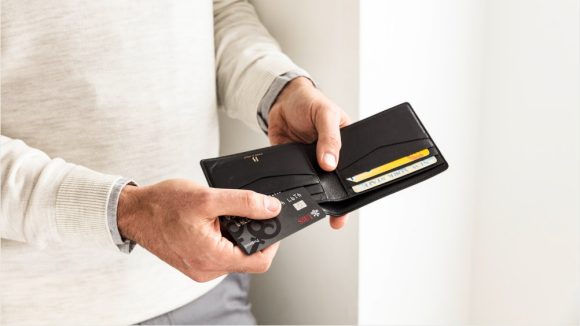 Man opening his wallet to take out a credit card