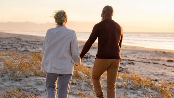 A couple walking on the beach.