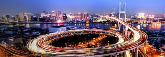 Time-lapsed shot of chaotic night traffic against a city-scape background