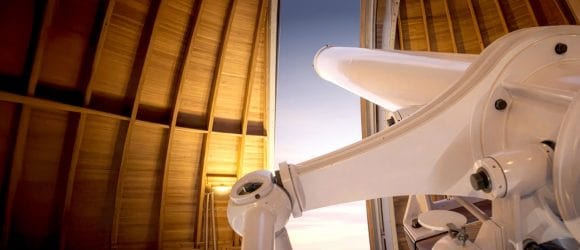 Closeup of a high-powered telescope looking into the sky