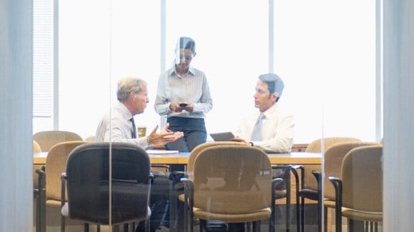 Three professionals having conversation