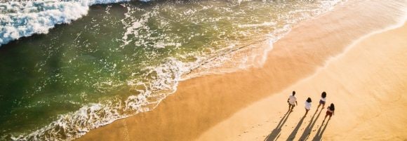 Family walking down the beach