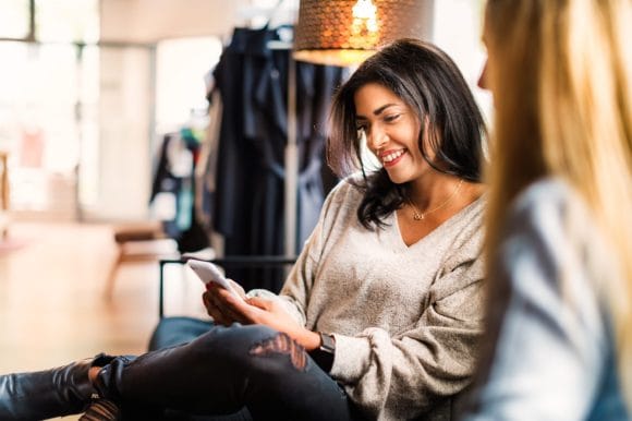 Woman reading message on smartphone