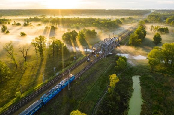 Passenger train crossing river