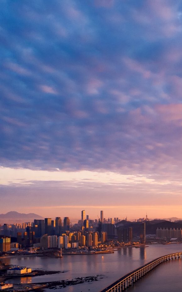 Coastal city with long bridge along its coastline