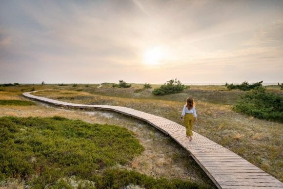 Woman walking on boardwalk