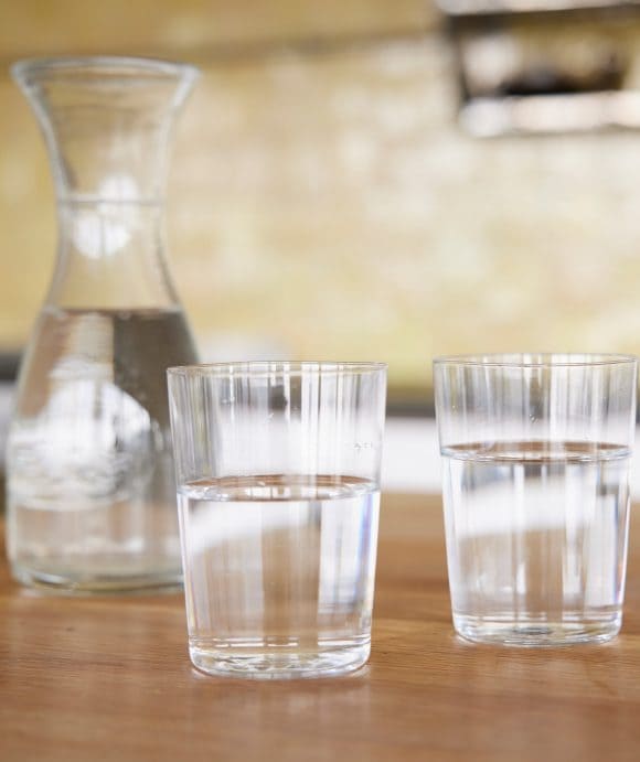 Table with a water carafe and two glasses of water