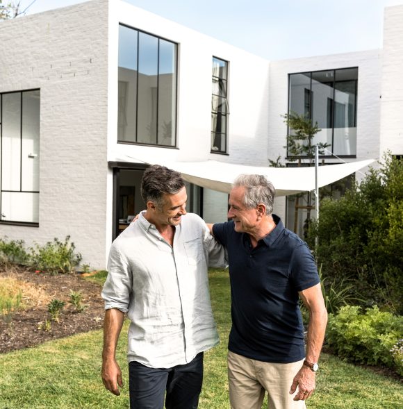 Father and son walk in the garden and talk.