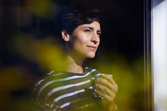 Mother hugging doughter when happily having a walk in mountains.