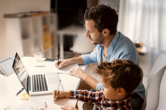 Part time father working at home and taking care of pre-school son.
