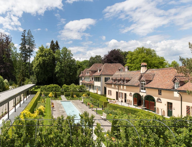 Wolfsberg Castle - the English garden with coach house and Parquin House