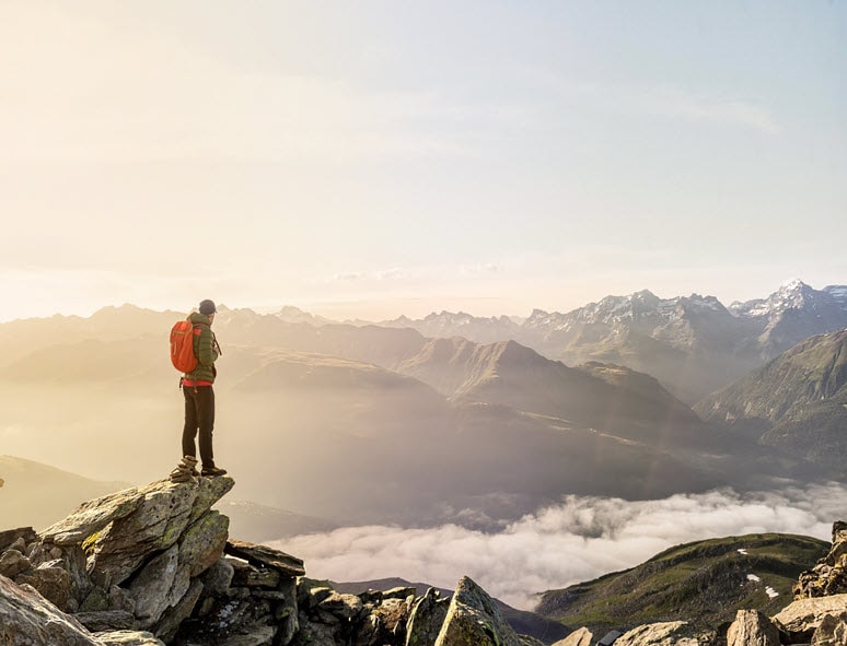 A man observes the horizon in the mountains