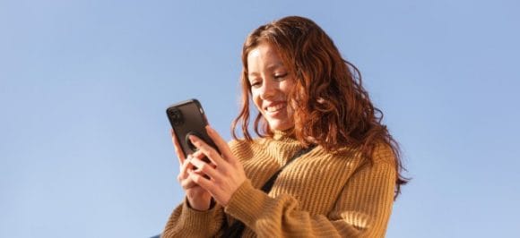 Young woman looking at her smartphone.