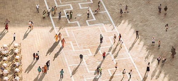 Aerial view of people walking across a square in Venice.