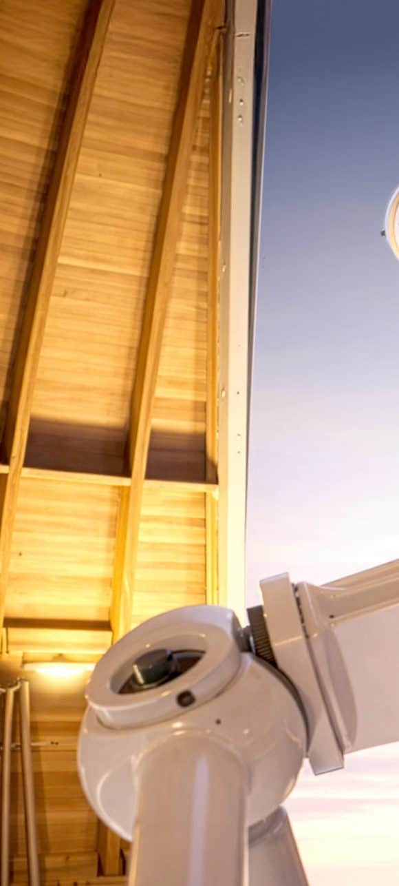 Closeup of a high-powered telescope looking into the sky