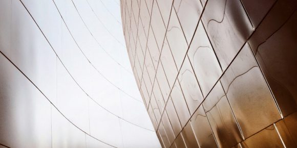 UBS Financial Advisor and a client walking next to a modern, curving architectural structure