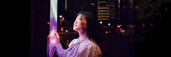 AIm high image with girl looking at a big screen.