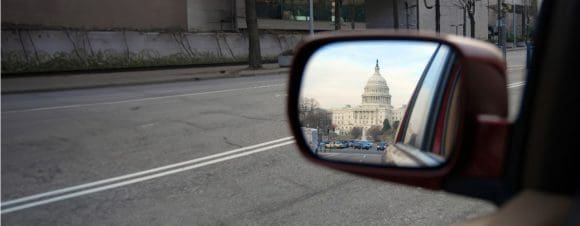 US Capitol building in rear view mirror