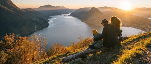 Family on mountain top overlooking Lake Lugano