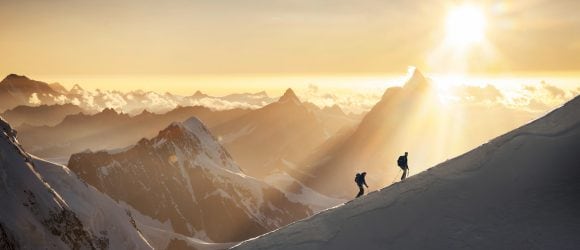 Mountaineers on snowy ridge of Monte Rosa mountain