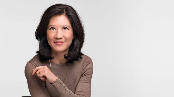 Smiling young woman looking up.
