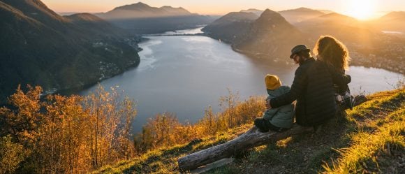 Family on mountain top overlooking Lake Lugano