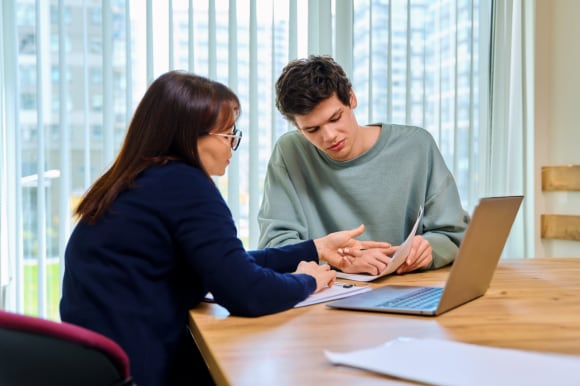 Two colleagues looking at papers and discussing