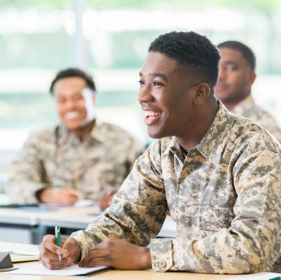 veterans smiling and sitting at a table