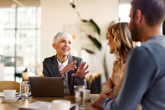 Senior client advisor talking to couple
