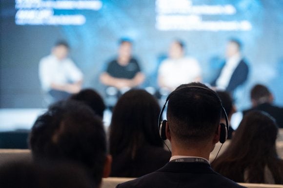 Audience wearing headphone listening to the autonomous driving session