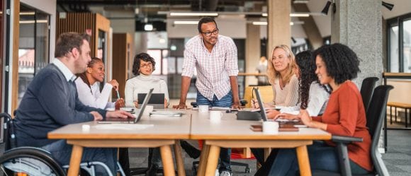 Colleagues gathered around a table for an informal meeting.