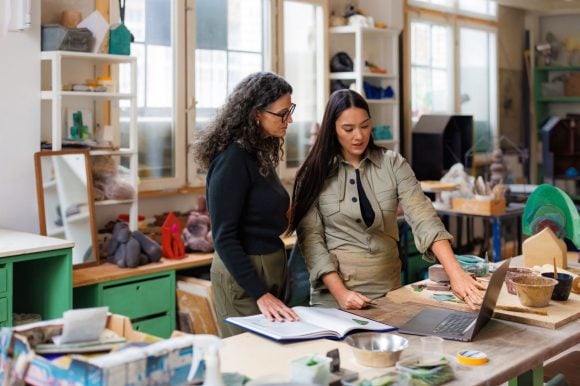 Various colorful glasses on a wooden table