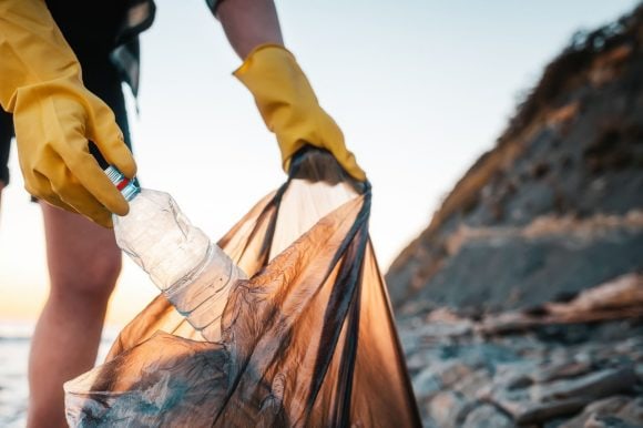 Women collecting trash on beach