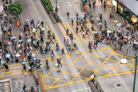 People and cabs crossing crossroads
