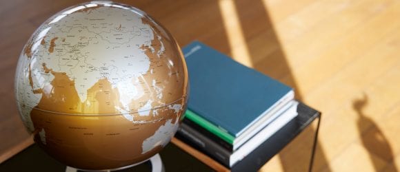 Globe and books on table