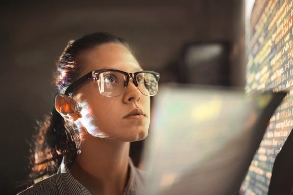 Woman looking at wall with computer code