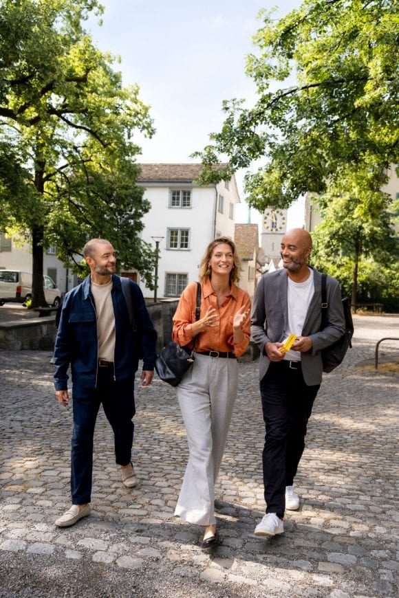 Two men walking in a field of windmill