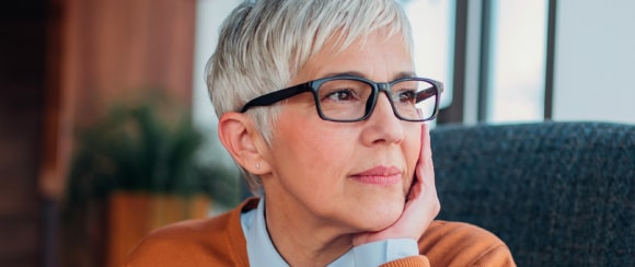 women with glasses looking at the window
