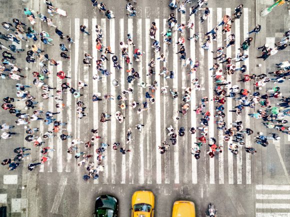 People and cabs crossing crossroads