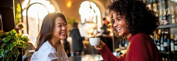 Two friends having coffee