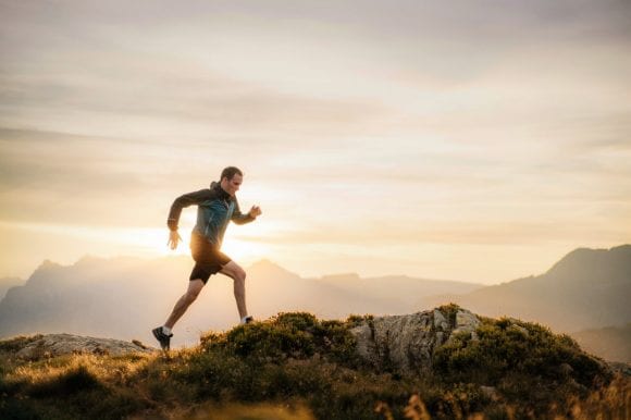 Man running on mountain ridge