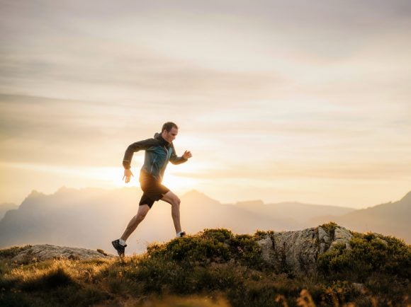 Man running on mountain ridge