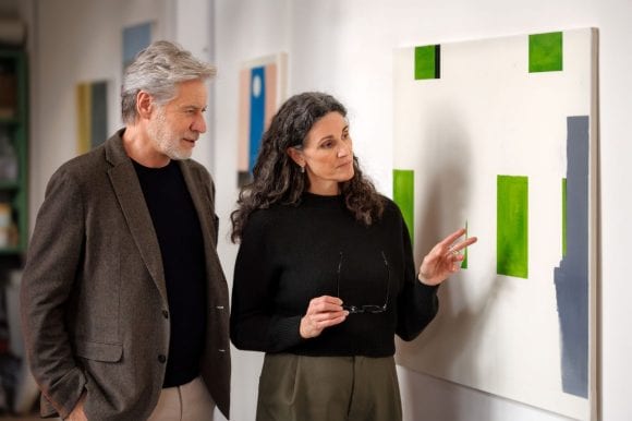 A man and a woman looking at an artwork