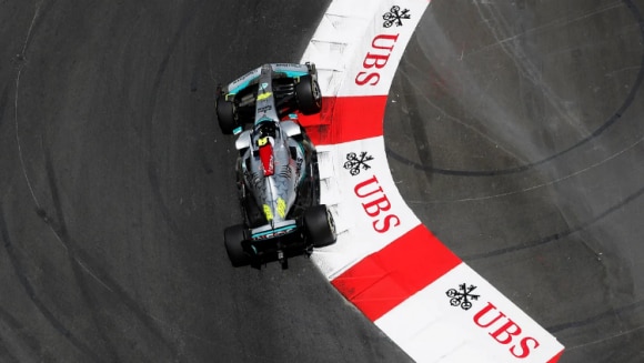 Formula one car on a race track near UBS logo