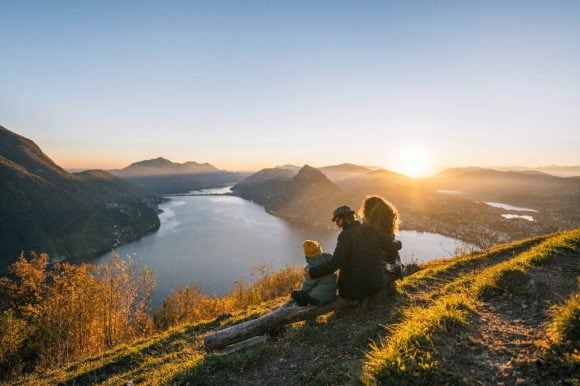 Family on mountain top overlooking Lake Lugano