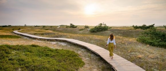 Woman walking on boardwalk