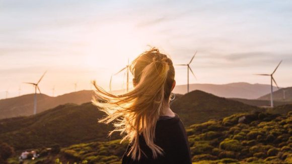 Women looking at the mountains with windmills